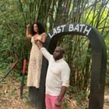 An African-American couple in a park under sunlight with a blurry background